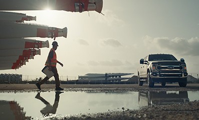 A man walking towards a Ford F150 truck